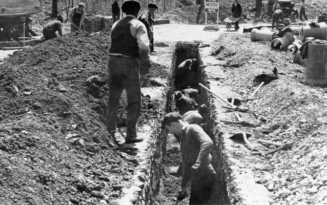 Project #2281 District 6: WPA Project #2281 provides for the construction of sewer laterals on Dundee Road and Richmond Drive, City of Louisville, KY. Photograph taken April 13, 1936, shows men excavating trench to a depth of 4.5 feet on Dundee Road