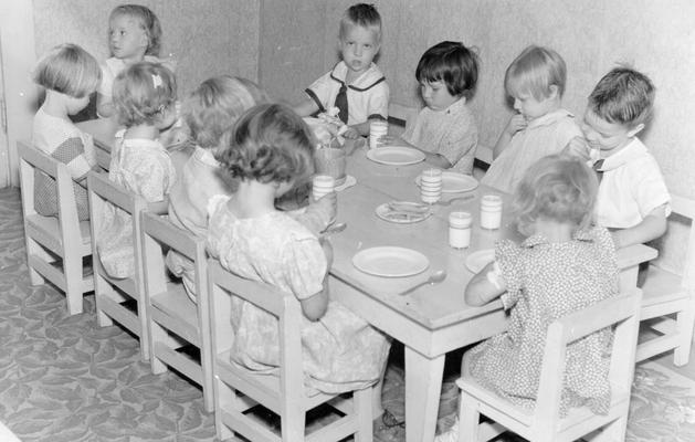 Project #2136 District 5: Another view of children enrolled in the Ashland, KY, Nursery School, showing them ready to drink their milk at the start of lunch