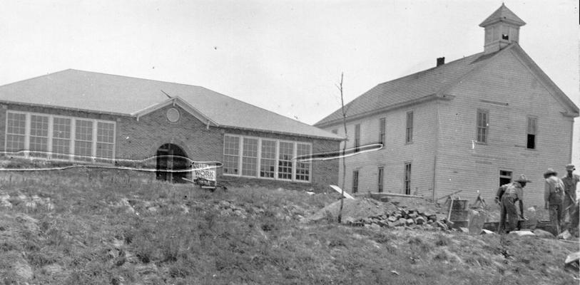 Project #861 District 1: New brick-veneer, four-room high and graded school building at Hampton, KY, and the old two-story frame structure it will replace. The new building was constructed under WPA Project #861, which also provides for demolition of the former schoolhouse. View was photographed June 10, 1936