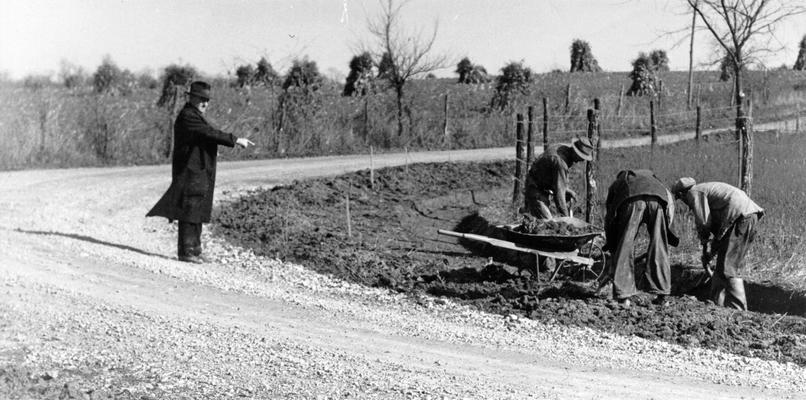 Project #2784 District 6: Firman Road Project, Jefferson County. View, photographed November 11, 1935, showing a curve on the Firman Road being super-elevated and widened on the inside. This work is part of that being undertaken under Master Project #2784, which provides for repairing and improving various roads not in the Federal Highway System in Jefferson County
