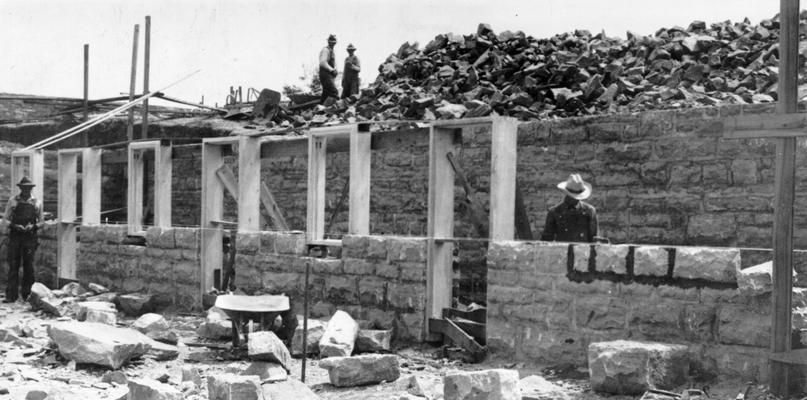 Project #1965 District 2: Construction of stadium, Campbellsville, KY. View, photographed June 11, 1936, shows partially completed stone basement walls of the stadium being constructed under Project #1965 for the graded and high school at Campbellsville, KY. Construction will be of native stone and concrete