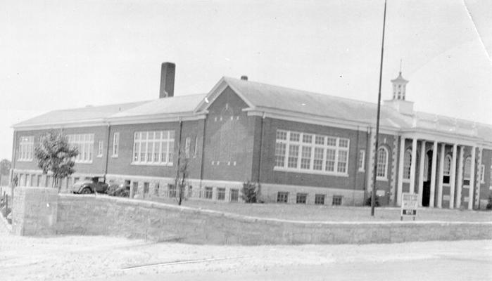 Project #1459, Master Project #2815 District 3: View of the Athens High School Building in Fayette County, showing completed exterior of the addition to the building. The addition begins between the tow single windows above the parked automobile, and extends to rear of the structure. Photograph was taken July 10, 1936