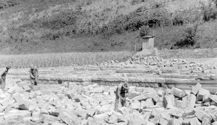 Project #734 District 5: Construction of an 8 classroom school building with gymnasium and auditorium combined near Ary, KY. View, photographed June 23, 1936, facing from the west side of the building site, shows workmen cutting native sandstone used in construction of the building