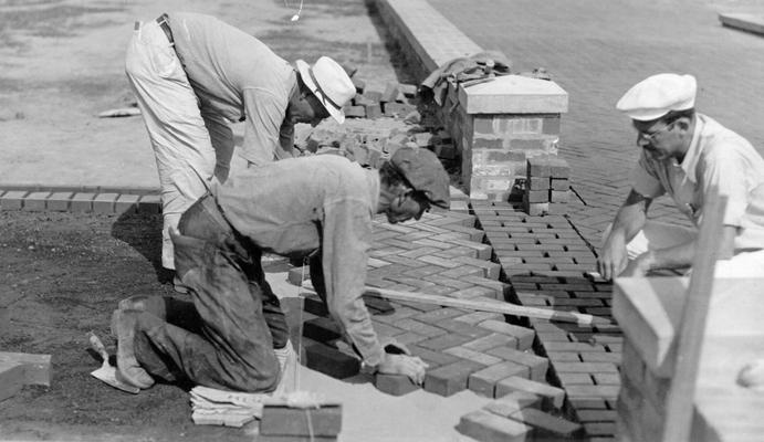 Project #120 District 6: Cypress and Algonquin Parkway Playground, Louisville, KY. View, photographed July 22, 1936 at the newly developed playground at Cypress and Algonquin Parkway shows workmen finishing the brick walks leading to the wading pool