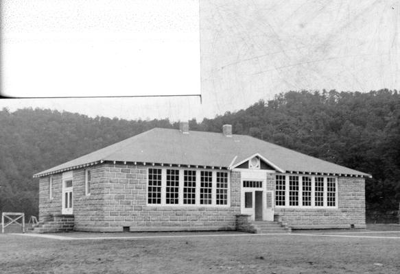 The picture on the cover of this issue of the Narrative Report draws a sharp contrast between an old dilapidated schoolhouse, appearing in the inset, and a modern school building. The former is one of a number in Kentucky now being replaced by WPA constructed school buildings, of which the one shown is a typical example. It is a four-room school of native sandstone, quarried on the project