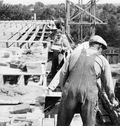 Project #1940 District 2: Project #1940 is the construction of a building containing a gymnasium, four classrooms and a basement in the City of Columbia, KY. Brick masons at work on a wall of the gymnasium building. View photographed August 3, 1936