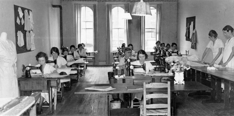 Project #182 District 4: Winchester, KY, Training Work Center. Project #182 is the operation of a Training Work Center at Winchester, KY. Women are employed on this project to make wearing apparel and other articles, which are distributed by the sponsor to needy families. View of the (white) Women's Training Work Center, photographed October 16, 1936