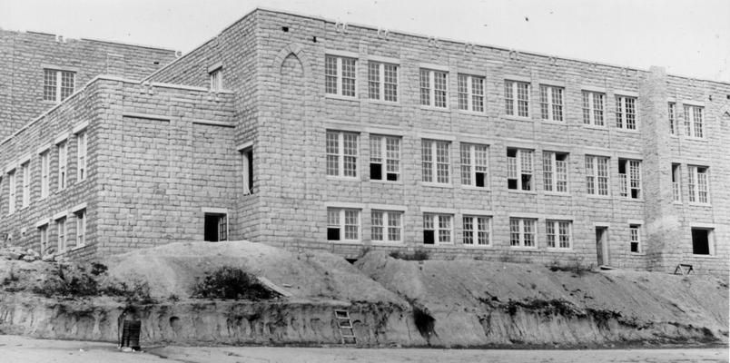 Project #496 District 5: A native stone school in Morgan County. Construction of a native stone school building at West Liberty, KY. This building, 108' X 156' in dimension, is constructed of squared stone masonry. It has two stories and a basement. Project was started under K.E.R.A. The West Liberty School viewed from the rear. View photographed October 5, 1936