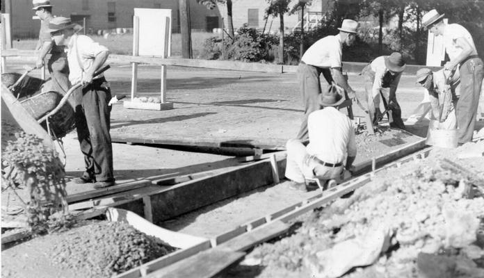 Project #2981 District 6: General improvements to the Park system in Louisville, Ky, are being made under Project #2981. Men pouring concrete for the new curb and gutter on Eastern Parkway. Photograph taken September 16, 1936, is on the right side of the Parkway facing Floyd Street