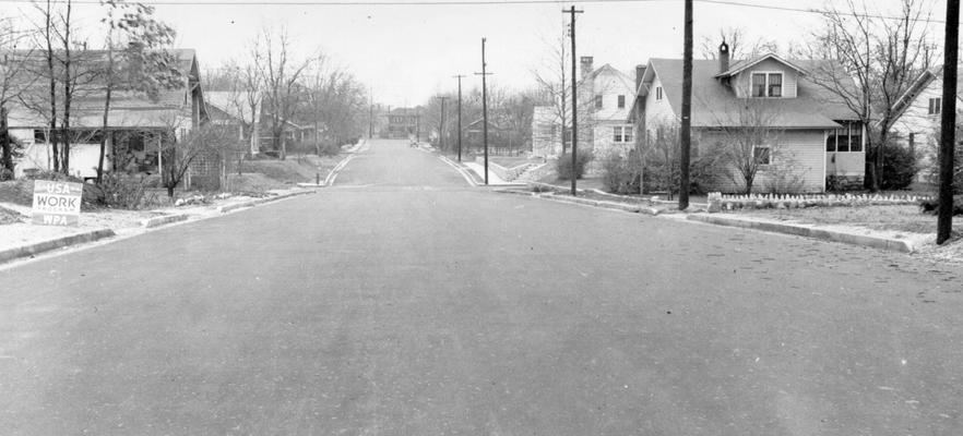 Project #804 District 6: Project #804 is for constructing 15,442 square yards of streets with curb and gutter in Bowling Green, KY. These streets are to be surfaced with bituminous retread base and native rock asphalt topping. View shows completed asphalt surface on Eleventh Street, photographed January 7, 1937