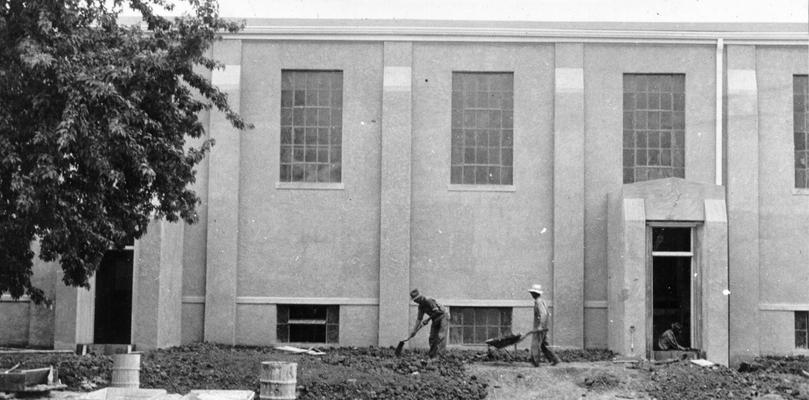 Project #1115 District 2: Construction of a concrete brick auditorium-gymnasium building for the graded and high school at Mackville, KY. View showing gymnasium nearing completion, photographed June 26, 1936. Workmen are grading the grounds