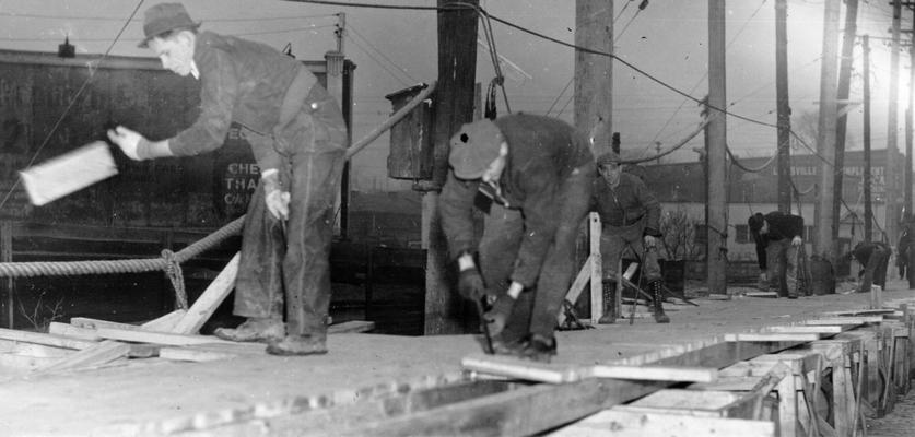 1937 Flood. Rescure work at Catlettsburg, KY. WPA workers rescuing a Negro woman from the second floor of her home at Catlettsburg, KY. View was photographed January 26, 1937