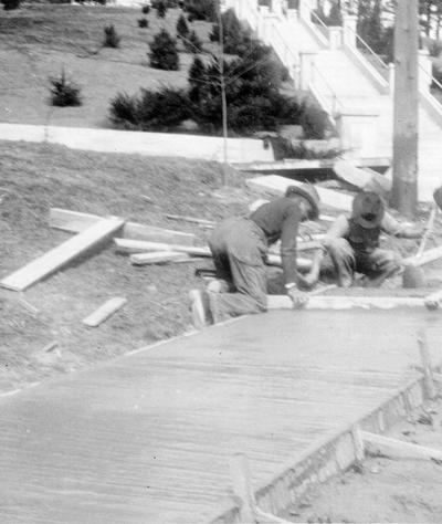 Project #236. Constructing 50,580 square feet of concrete sidewalk on various streets in the City of London, KY, became possible through WPA Project #236. Workmen putting the rough finish on concrete sidewalks at London, KY. Photographed February 27, 1936