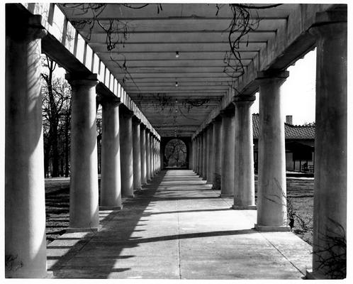 Unidentified outdoor covered walkway, with large concrete columns on both sides
