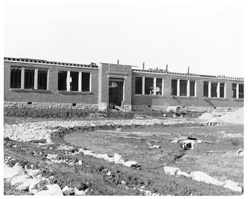 Unidentified brick school building under construction