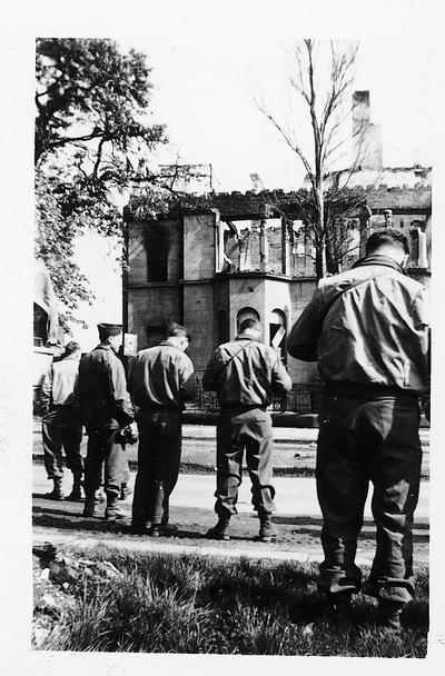 Germany, May, 1945; four soldiers taking pictures in a town