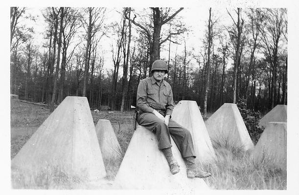 Siegfried Line, 1945; an American GI sitting on a tank obstacle