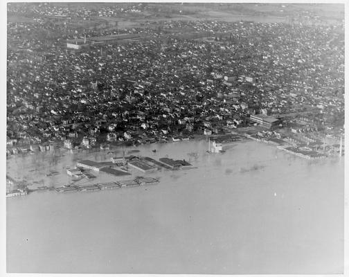 Aerial view of New Albany, IN showing section not affected by the flood waters  along with near submerged homes and factories - 1/27/37
