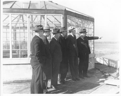 Group of well-dressed men overlooking flood - 1/27/37