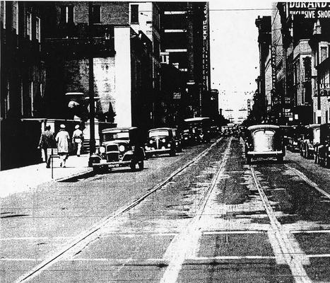 A downtown street scene; trolley tracks but no trolleys in view