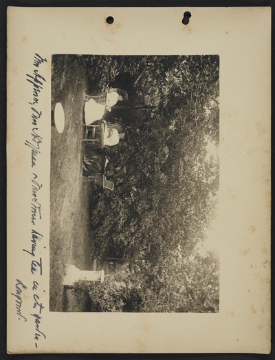 Mrs. [illegible], Mrs. Hoffman, and Mrs. [illegible] having tea in the garden- Longwood