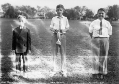 Rural School Tournament held at Stoll Field, left to right:  Mr. June Terry, Jack Jesse (with trophy) and N. Thomason
