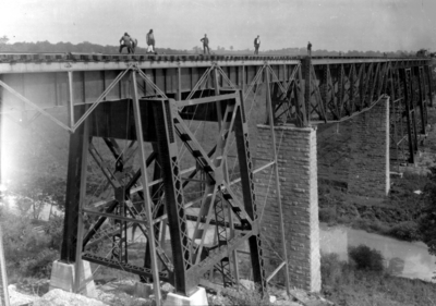 Men inspecting railroad bridge