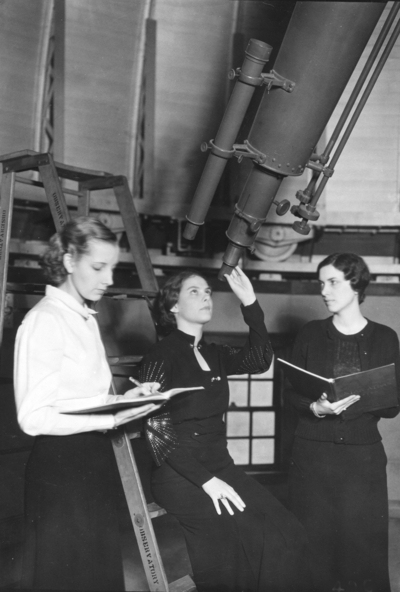Women viewing through a telescope