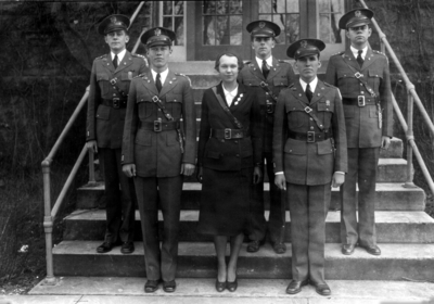 Five officers and a woman in uniform
