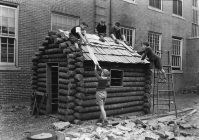 Children building a log cabin