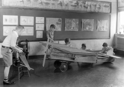 Children building a wooden airplane