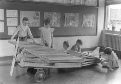 Children building a wooden airplane