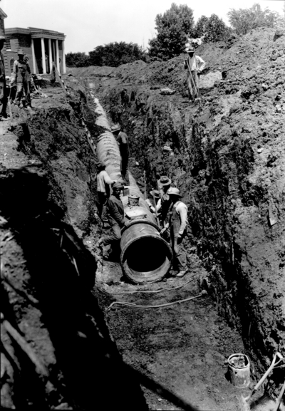 Workers laying pipe