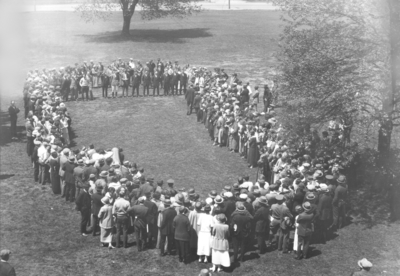 People forming circle in front of Administration building