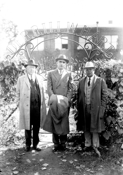 Professor James Thomas Cotton Noe, Terrill Hart? and Dean F. Paul Anderson at entrance to Dahlia garden