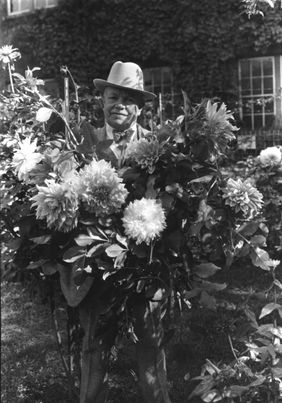 Dean F. Paul Anderson standing with the Dahlias