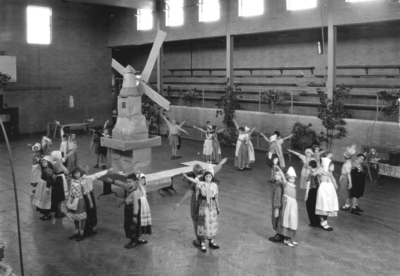 Children in Dutch costume around a homemade windmill