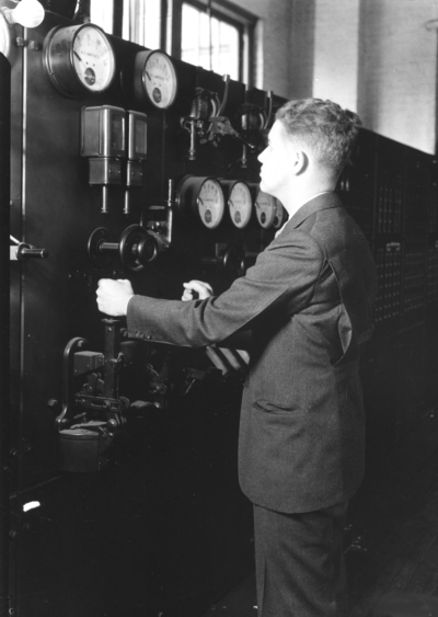 Man reading electricity meters