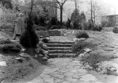 Woman standing at steps in the Botanical Garden