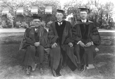 Richard Stoll in middle, Board of Trustees, and two unidentified men in Commencement gowns