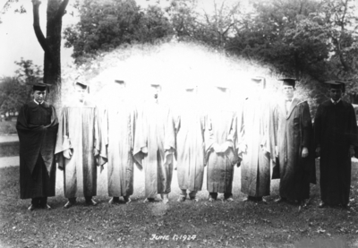 Nine people in commencement gowns