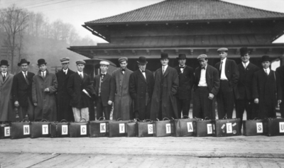 Engineering (class of 1910) trip to Norfolk, letters on briefcases spell 