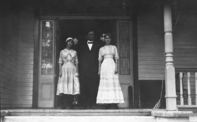 Two women and one man on front porch