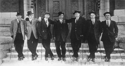 Seven unidentified men with canes