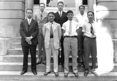 Group photograph, seven unidentified men, probably freshmen or high-school, in front of Frazee Hall