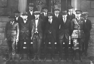 Twelve unidentified men in group photograph in front of Mathews Building