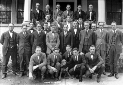 Group photograph, triangle fraternity, center right C. K. Hoffman bow tie, F. Paul Anderson's dog in center Jerry