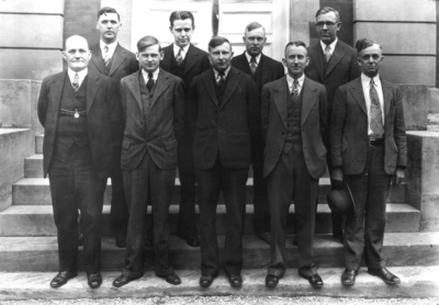 Group photograph on steps of Frazee Hall, connected with high school extension teachers, includes Kenneth Harding, Snapp