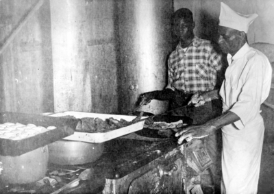 Two unidentified African-American men frying food