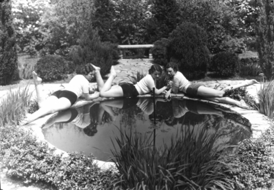 Three women by reflecting pool